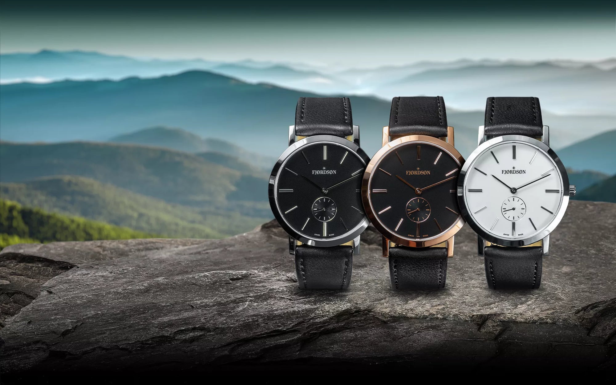 3 Fjordson #SLIM collection watches - 1. Black dial - silver | 2. Black dial - rose gold | 3. white dial - silver with vegan leather straps. Shot in a moody mountain area.