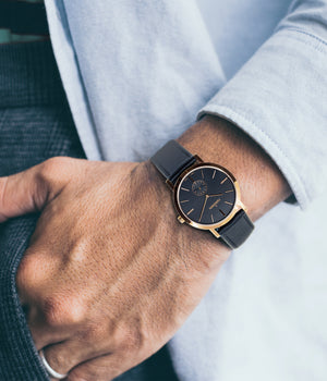 Man wearing watch - Fjordson watch with black dial and black vegan leather watch strap - UNISEX - vegan & approved by PETA - Swiss made
